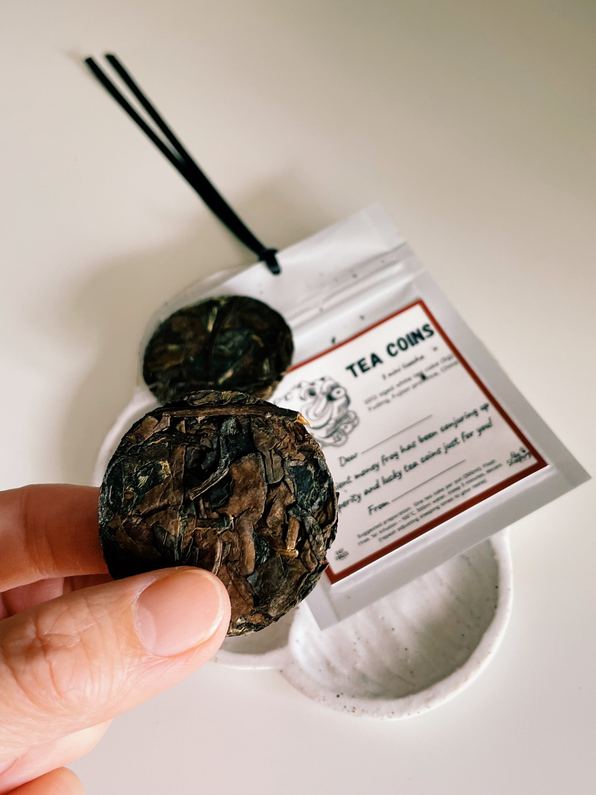 Tea coins with a label on a white background